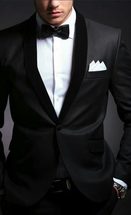 Modern black suit with velvet bow tie, shawl collar, and "crown folded" pocket square.