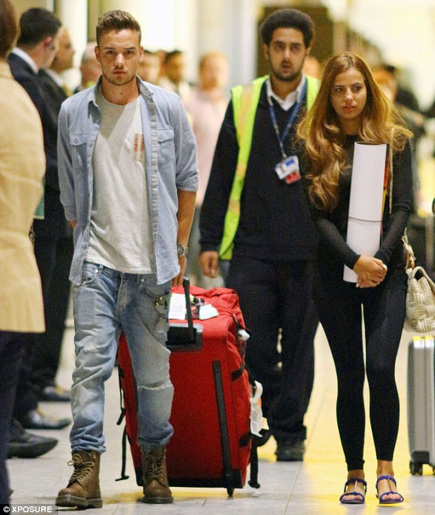 Getaway: Sophia and Liam dressed down as they made their way through the airport on Wednesday night ready to catch their flight